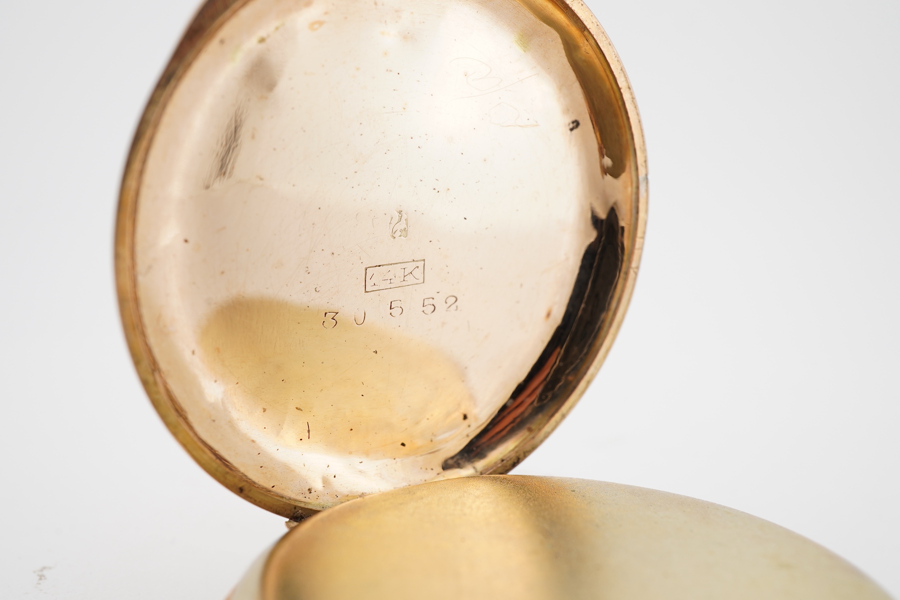 A lady's late 19th century Swiss engraved 14k keyless open faced fob watch, lacking glass, case diameter 32mm, with gilt metal inner cuvette, gross weight 27.6 grams.